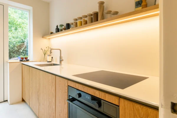 Eiken keuken met wit werkblad en open plank